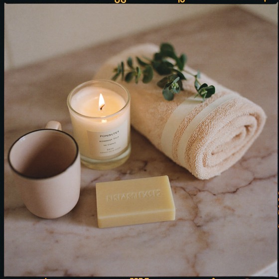Candle, towel, eucalyptus and tea on marble — intimacy wellness and self-care
